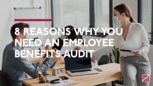 8 Reasons Why you Need An Employee Benefits Audit. Woman in office handing a document to an employee.