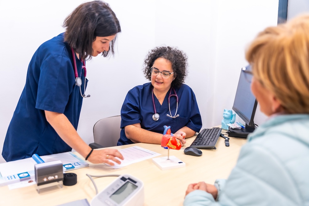 nurse and doctor discussing with patient